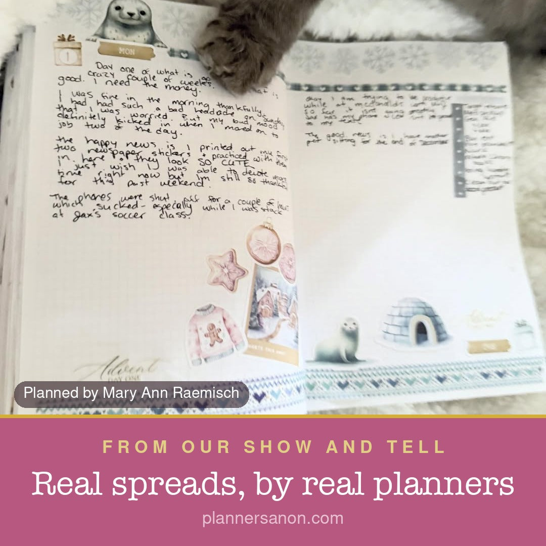 A cat beside an open decorated journal; Planned by Mary Ann Raemisch